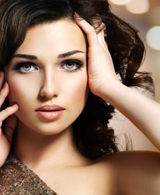 Portrait of a Beautiful young caucasian sexy woman. Pretty fashion model with dark brown eye makeup